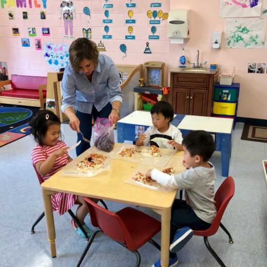 Three children crafting at a table.