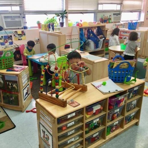 A classroom of children playing with toys.
