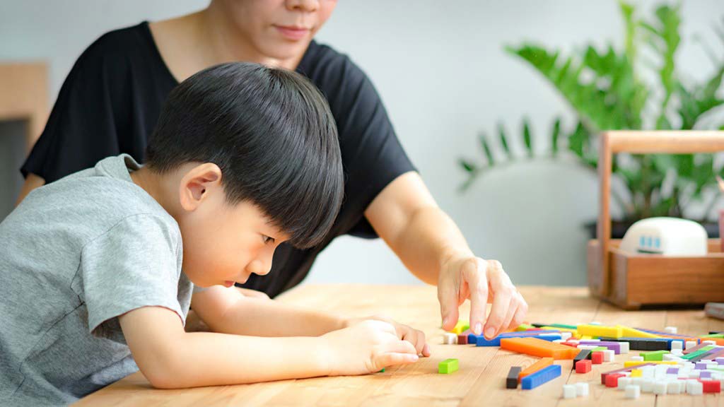 A boy playing with legos.