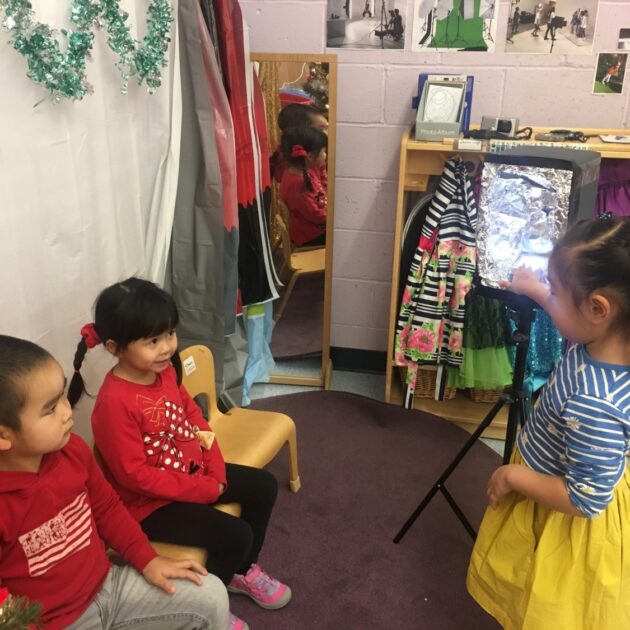 Three children in a classroom.